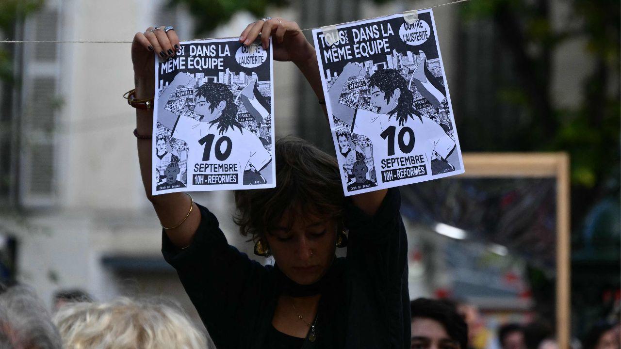 protester hangs up leaflets during a demonstration as part of the 